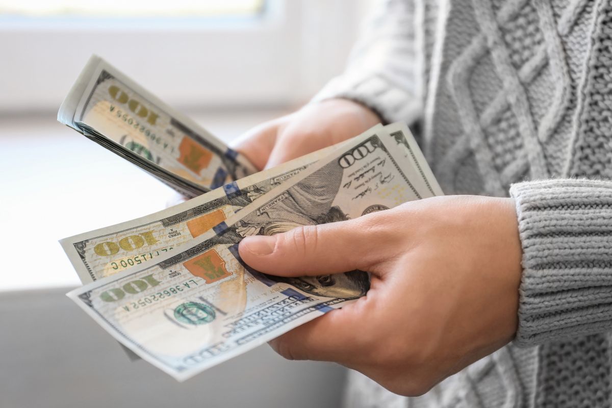 A woman's hand counting money.