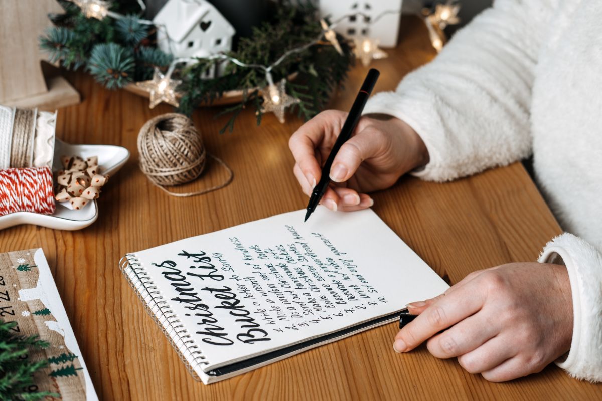 The image shows a woman creating a bucket list.