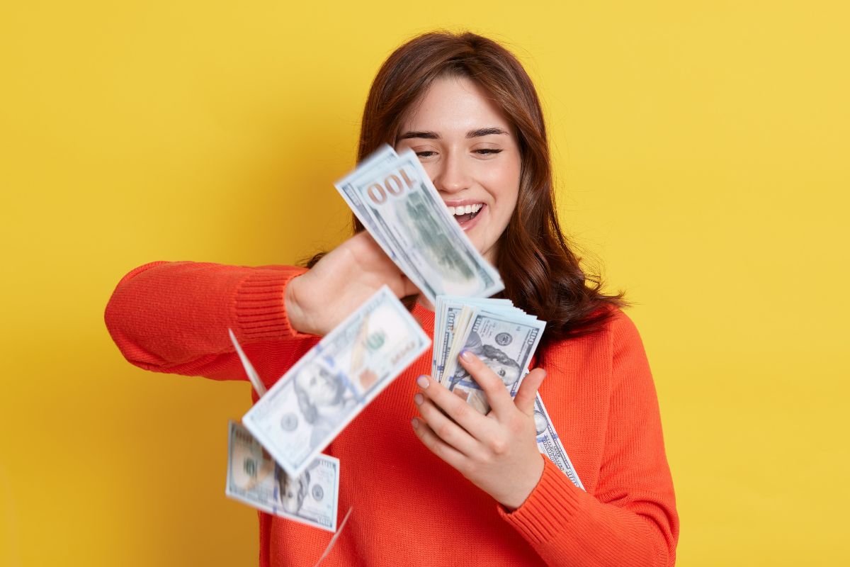 Image of a young lady throwing money.