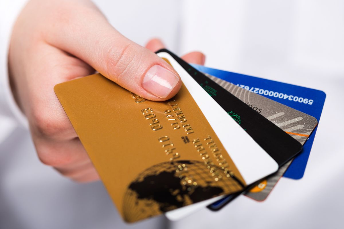 Image of a woman's hand holding credit cards.