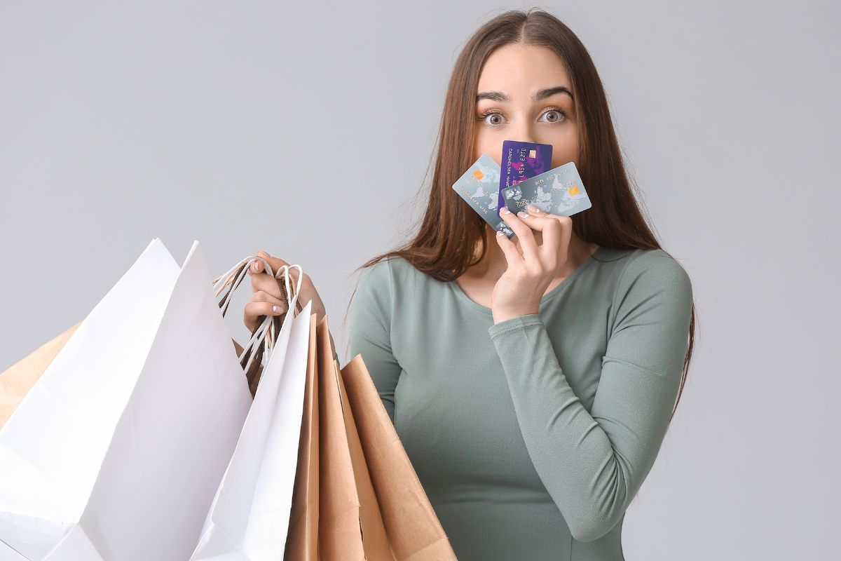 The picture shows a woman shopping with a credit card.