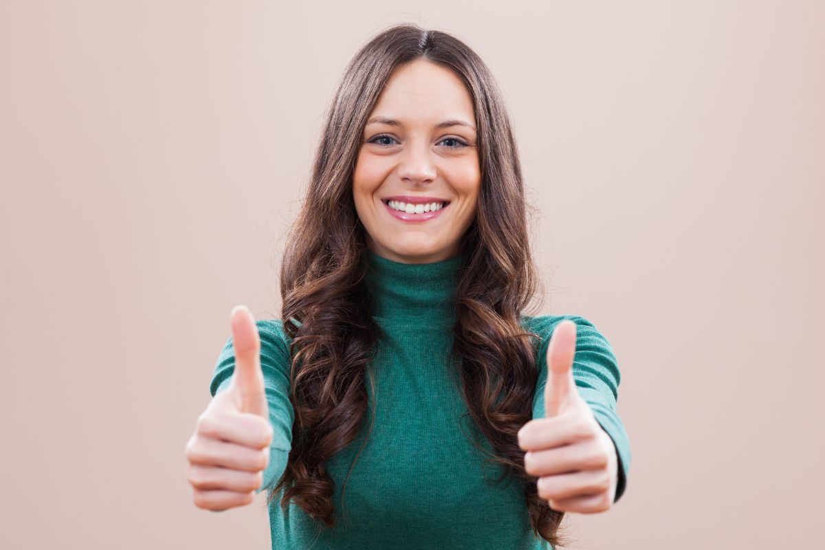 Photo of a woman doing an ok sign.