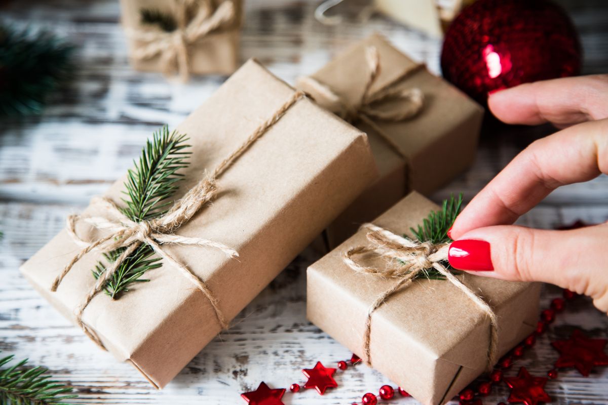Photo of a woman's hand creating small gifts.