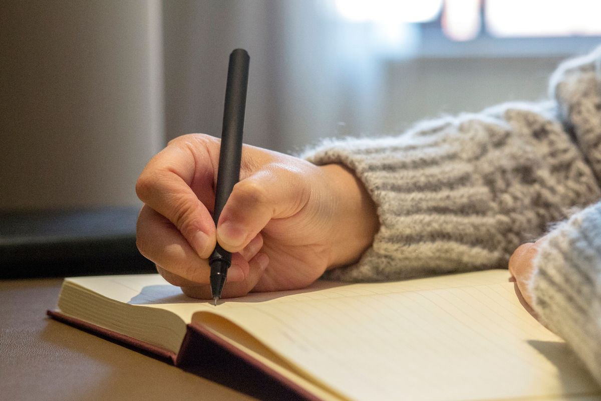 Photo of a woman who writes her budget.