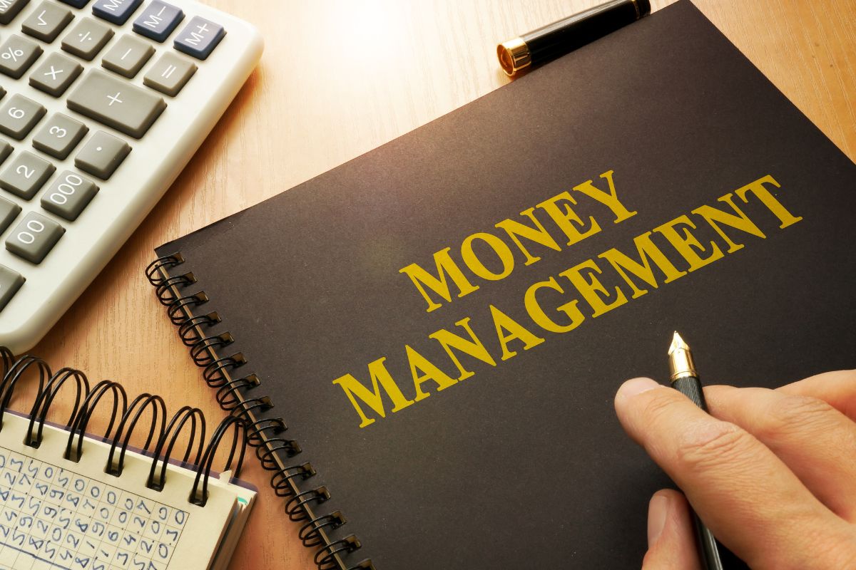 Picture of a notebook with money management wording.