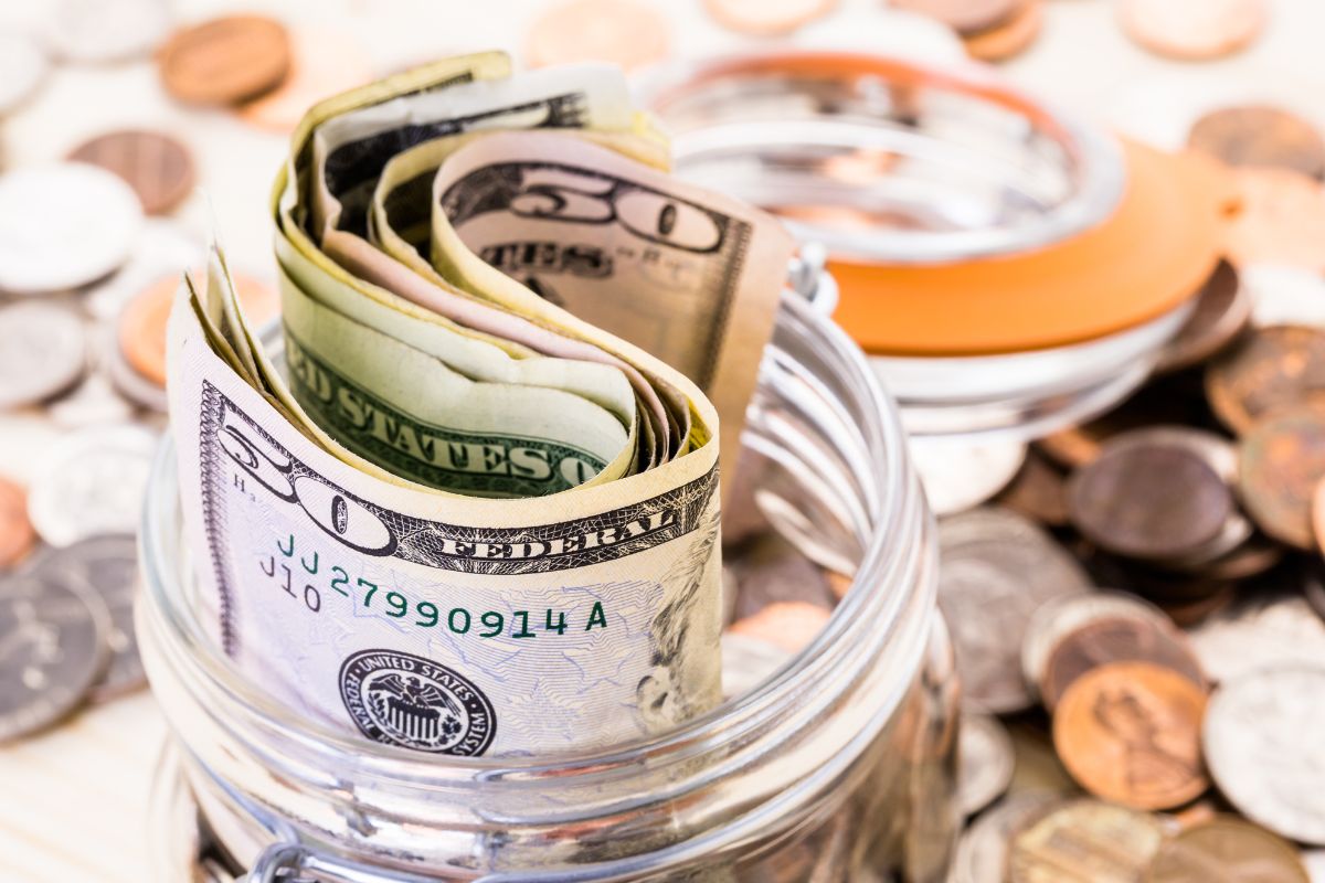 The picture shows a jar with money.