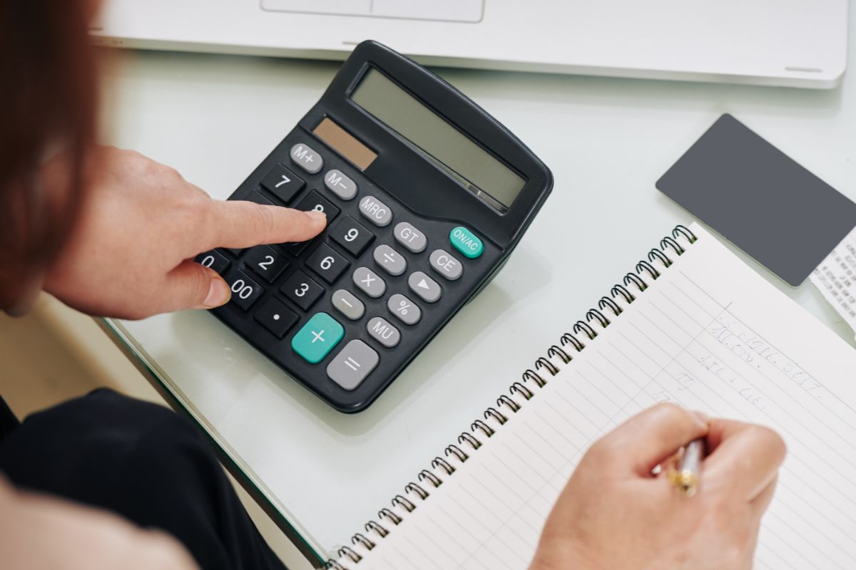 The photo shows a woman tracking her expenses.