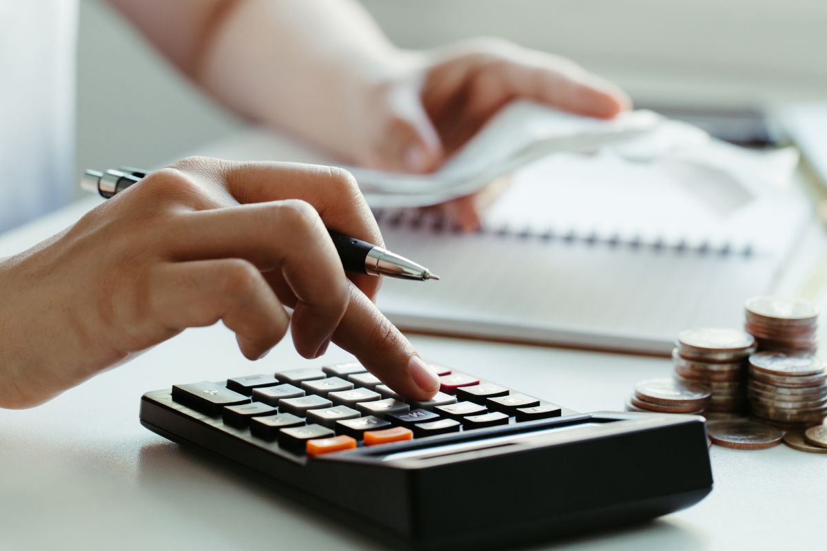 The image shows a woman budgeting.