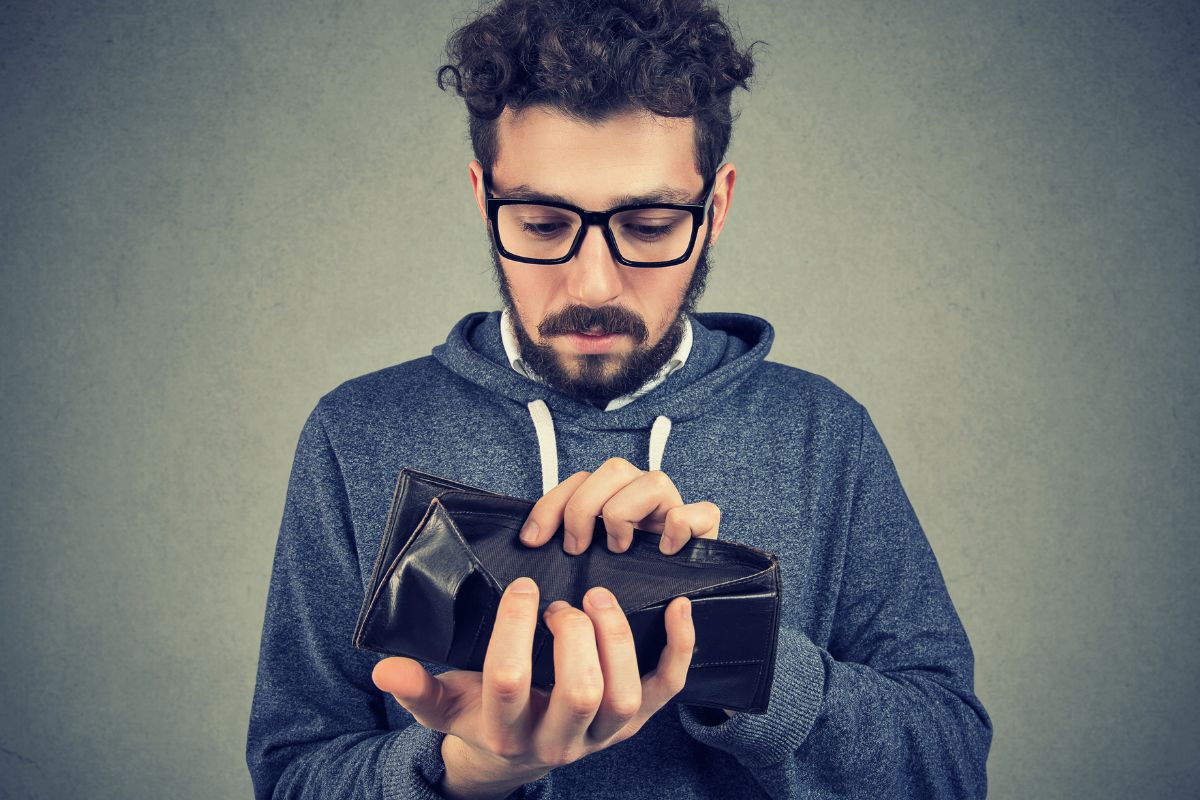 Image of a man with an empty wallet