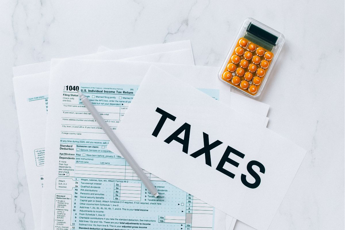 Photo of tax forms and a calculator.