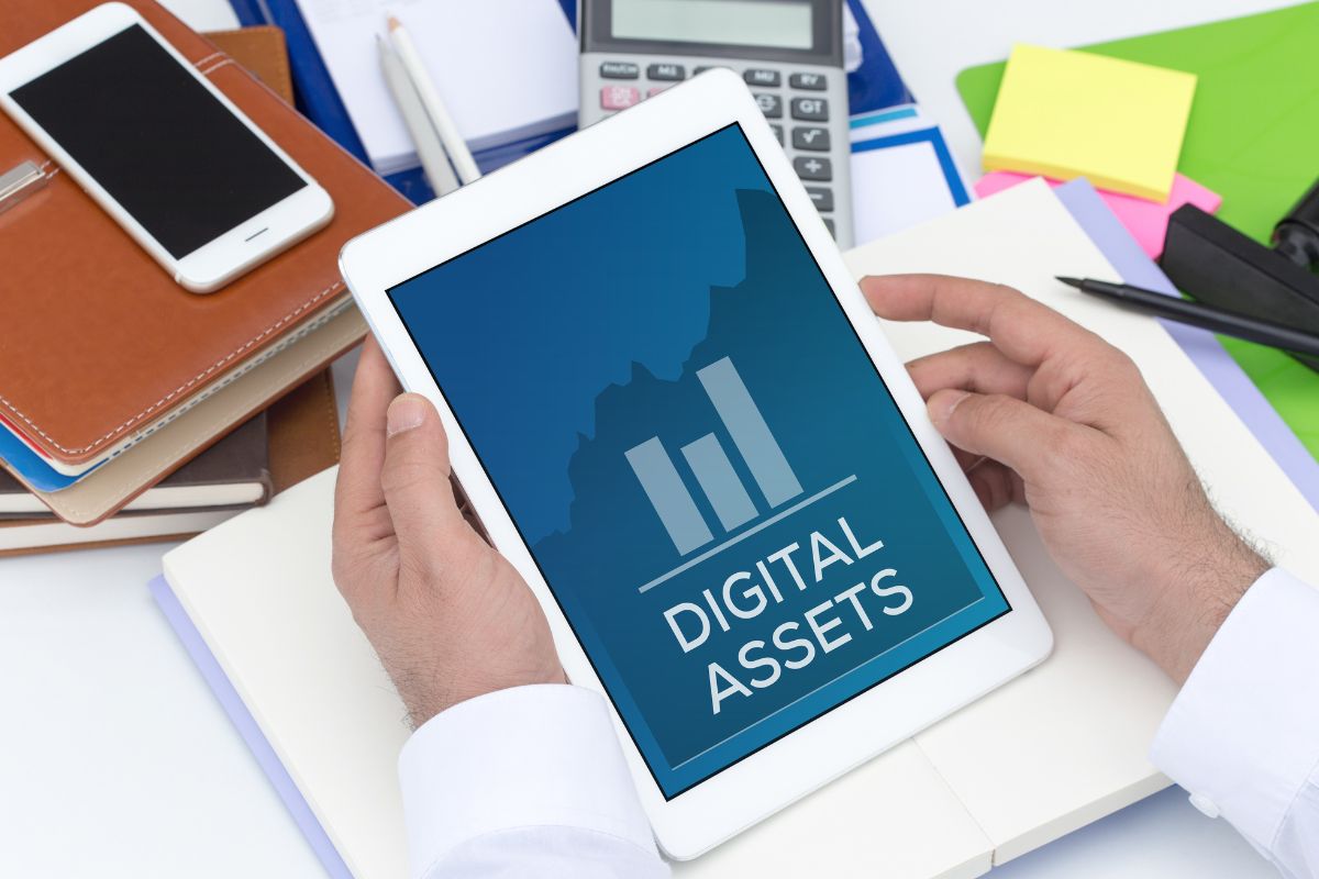 The picture shows a man's hand managing his digital assets.
