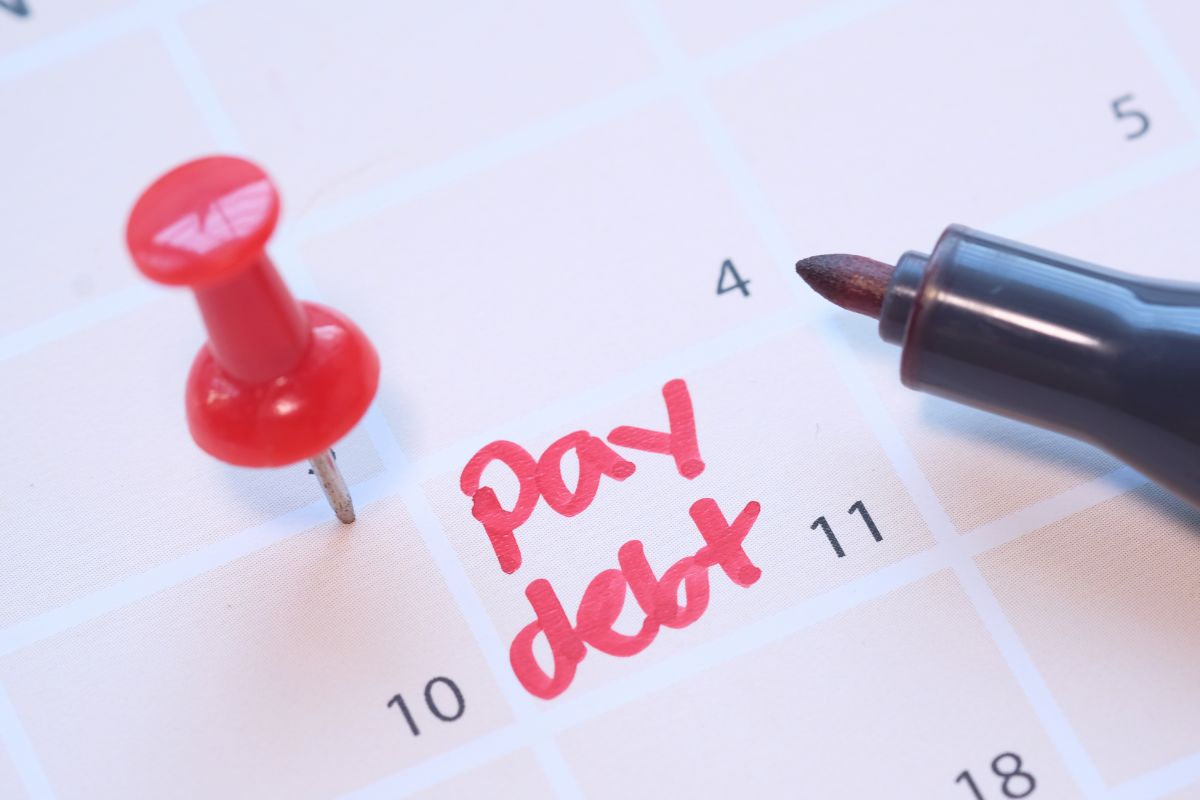 Image of a calendar with pay debt note.