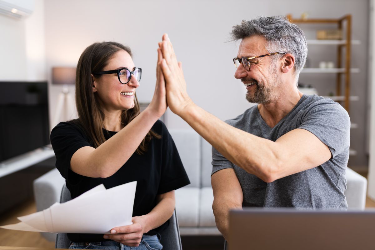 The image shows a couple cheering with success.