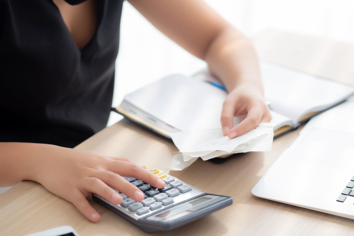 The photo shows a woman cutting unnecessary expenses.
