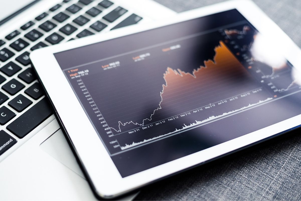 Picture of a tablet device with a stock graph.