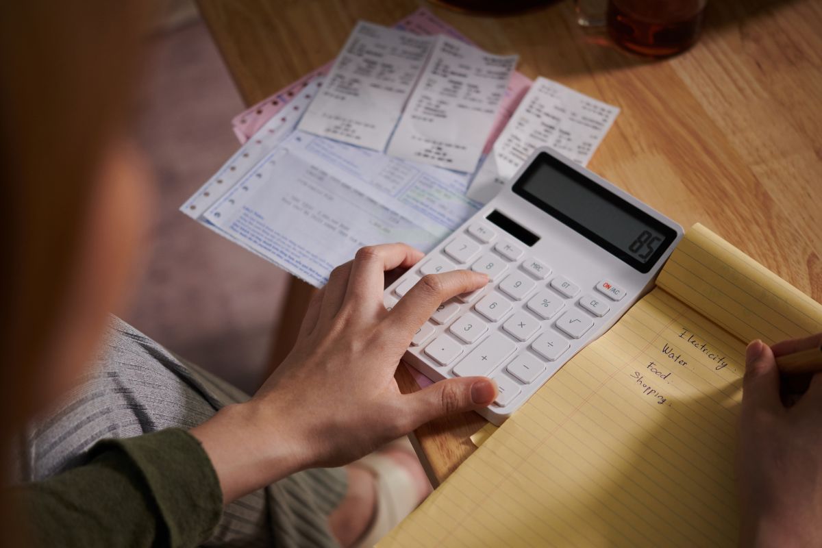 The picture shows a woman checking her expenses.