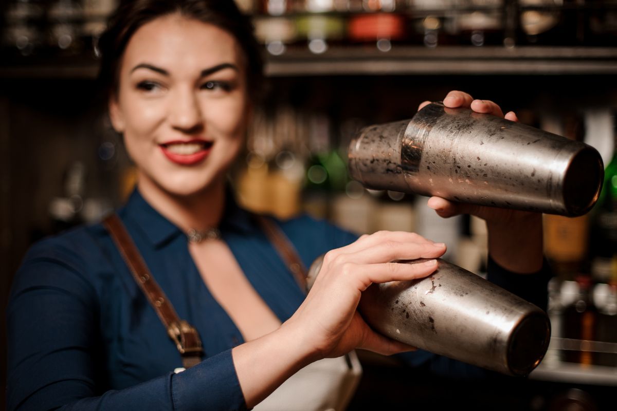 Picture of a bartender woman making a drink.