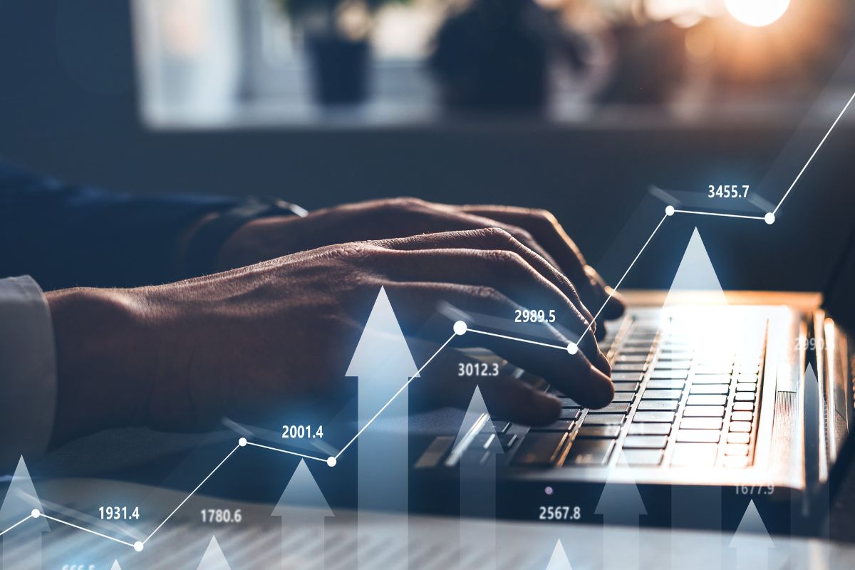 Photo of a man's hand trading stocks online.