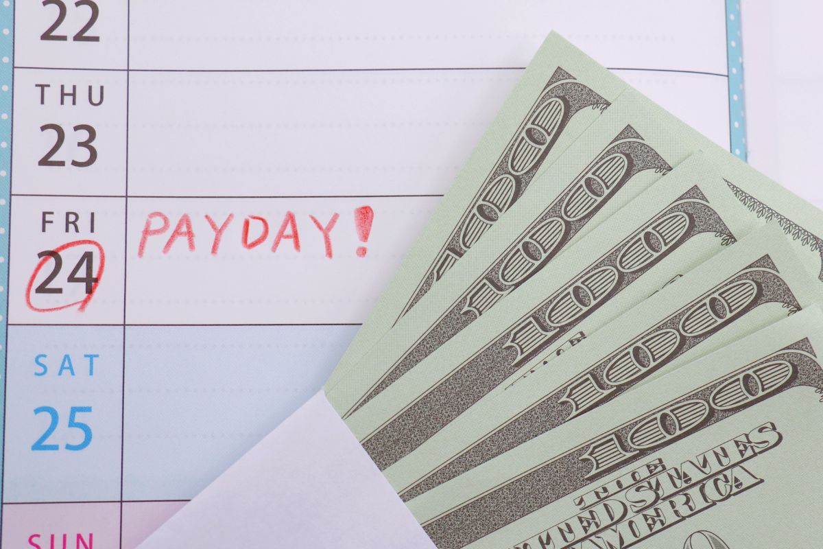 Image of a calendar with payday notes and money.