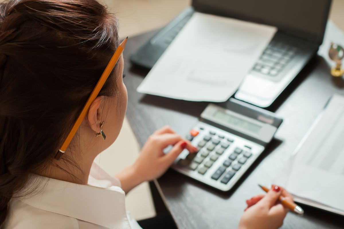 Image of a woman budgeting and tracking her spending.
