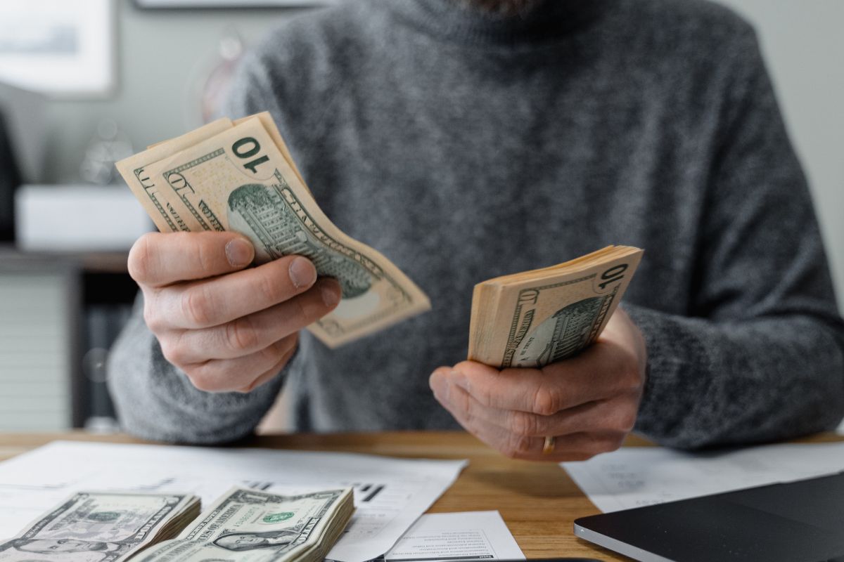 Image of a man counting money.
