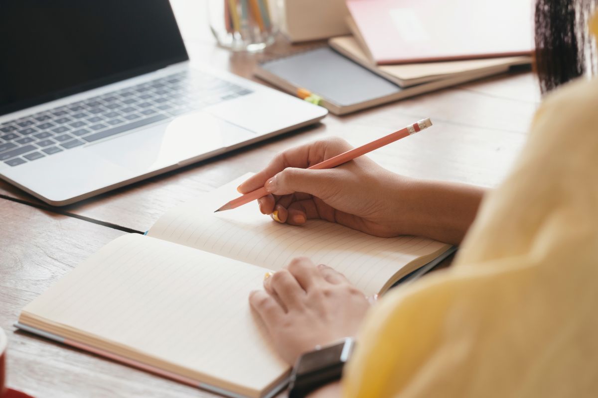 The image shows a woman learning to manage money online.