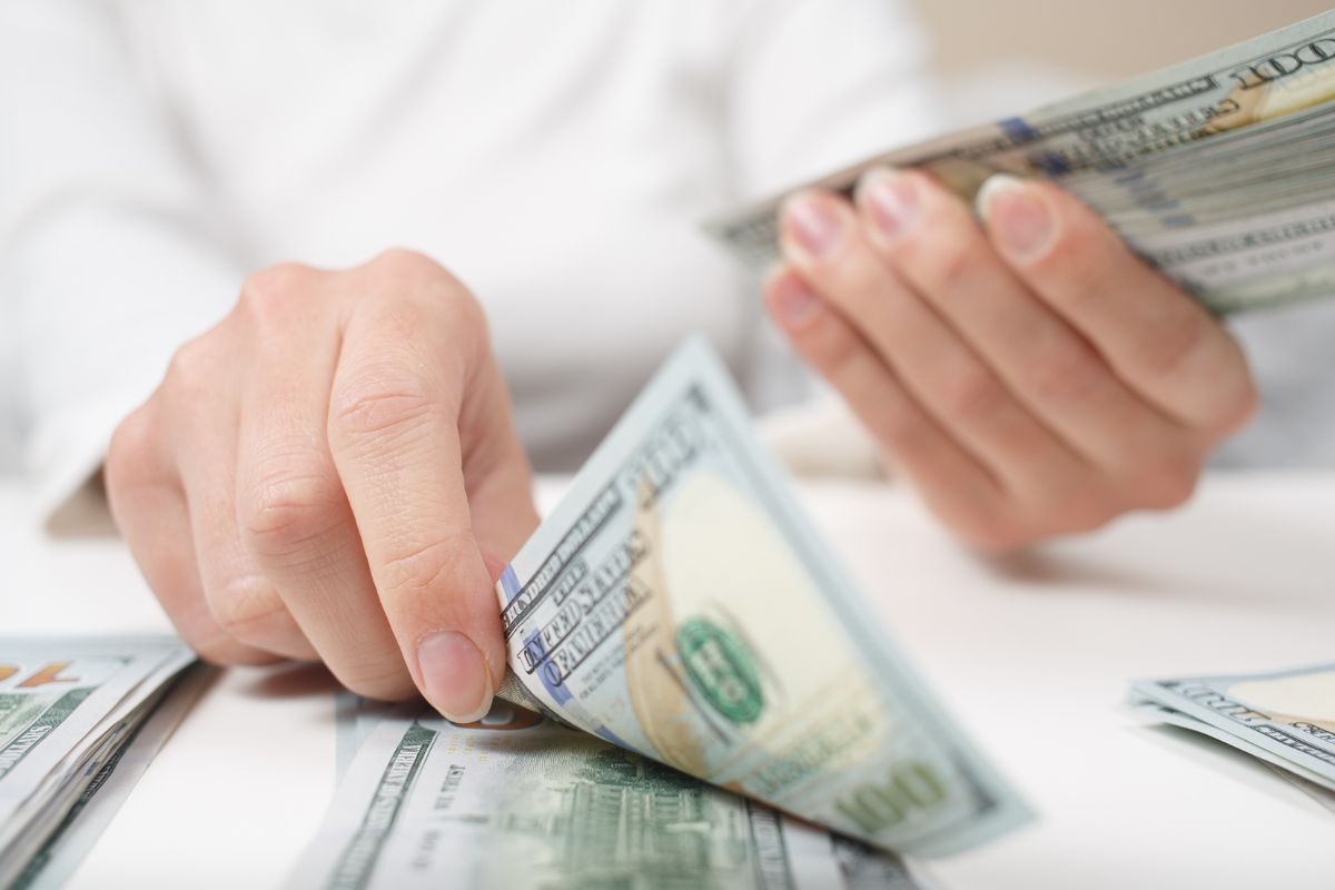 Picture of a woman's hand counting money.