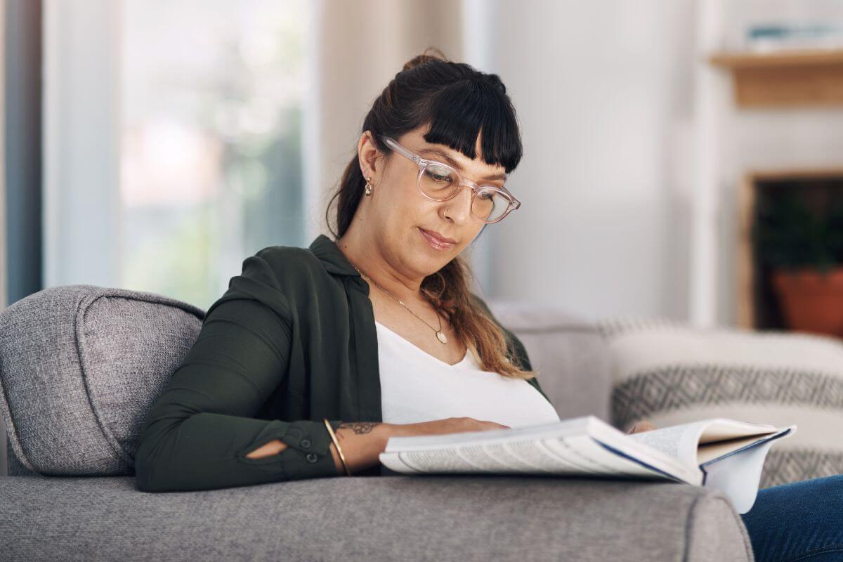 The image shows a girl reading a book which means that giving experience over gifts can encourage personal growth and learning new skills.