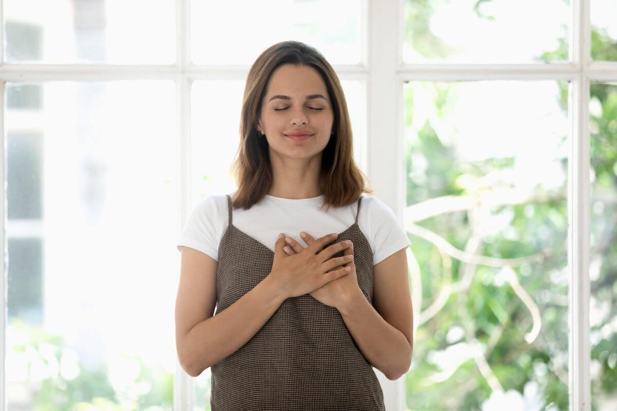 The picture shows a girl placing her hands on her chest indicating that giving experience over gifts can fosters gratitude and mindfulness or appreciate what they have.