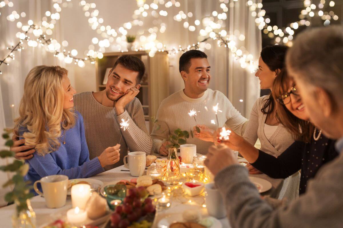 The photo shows food on the table and a group of people having fun together which means giving experience over gift can strengthen relationships that help build stronger connections with loved ones.