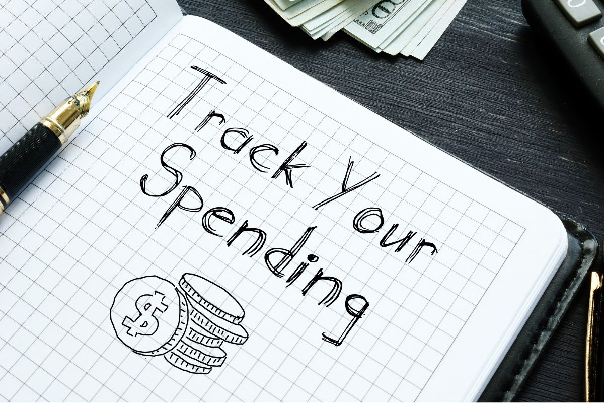 Picture of a notebook with Track your spending wording.
