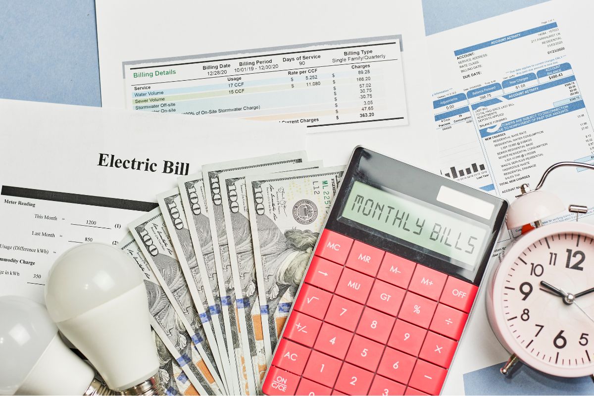 The photo shows monthly bills and money.