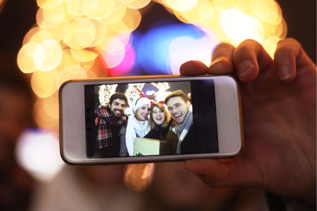 The image shows a group of friends taking a photo.