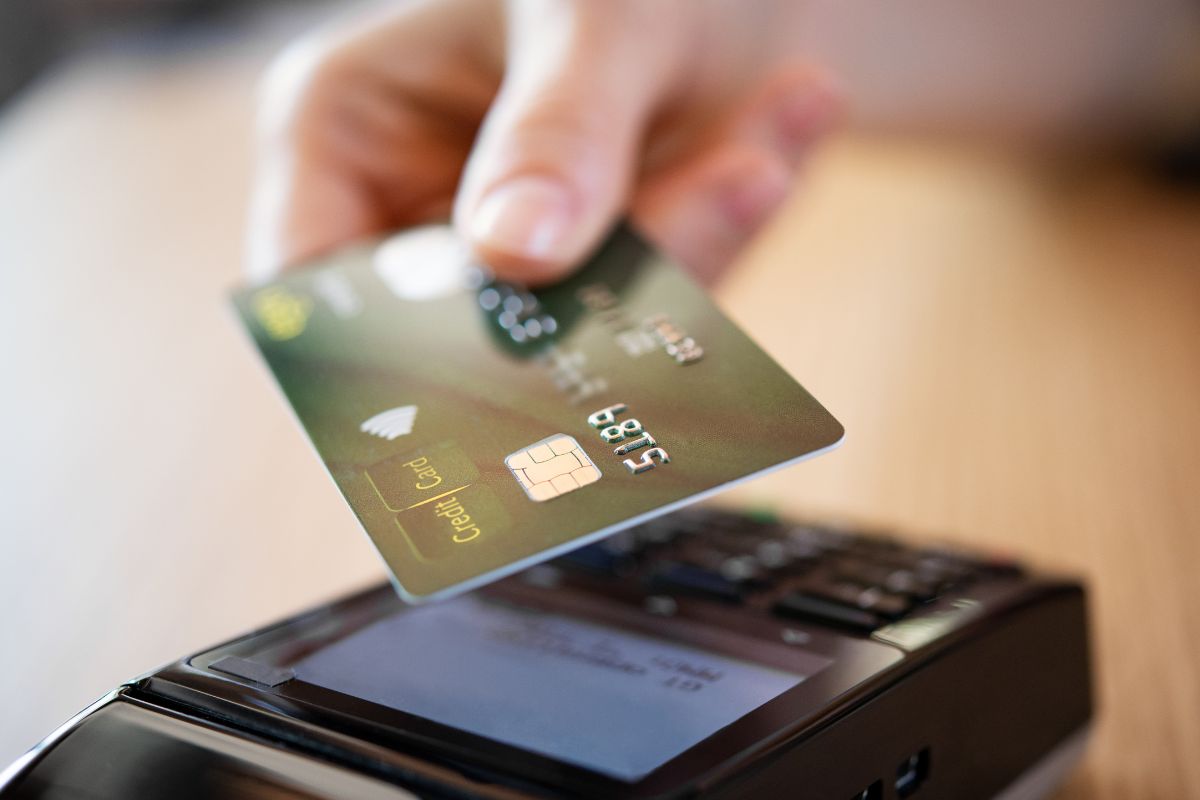 A woman's hand using a credit card.
