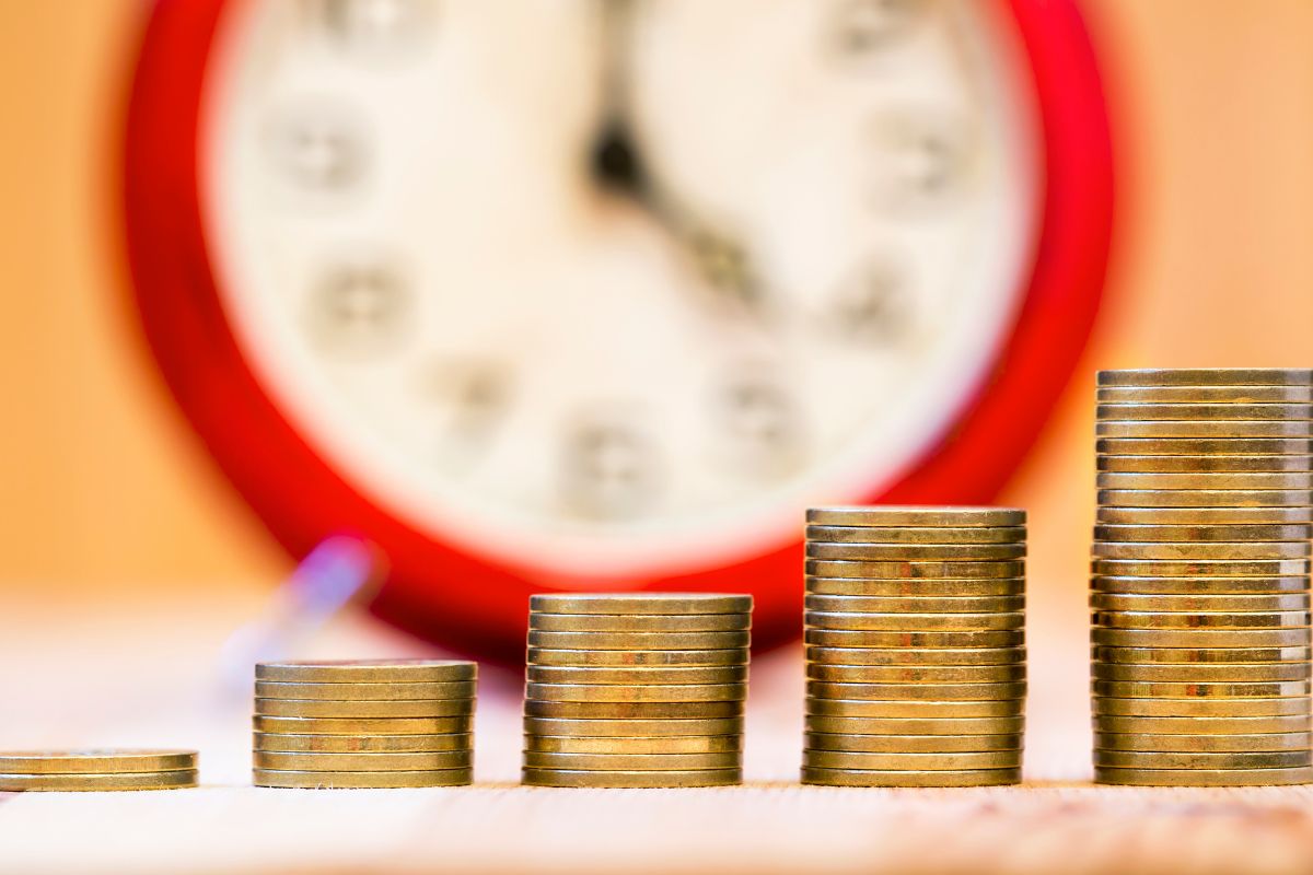 Image of stack coins and a clock.