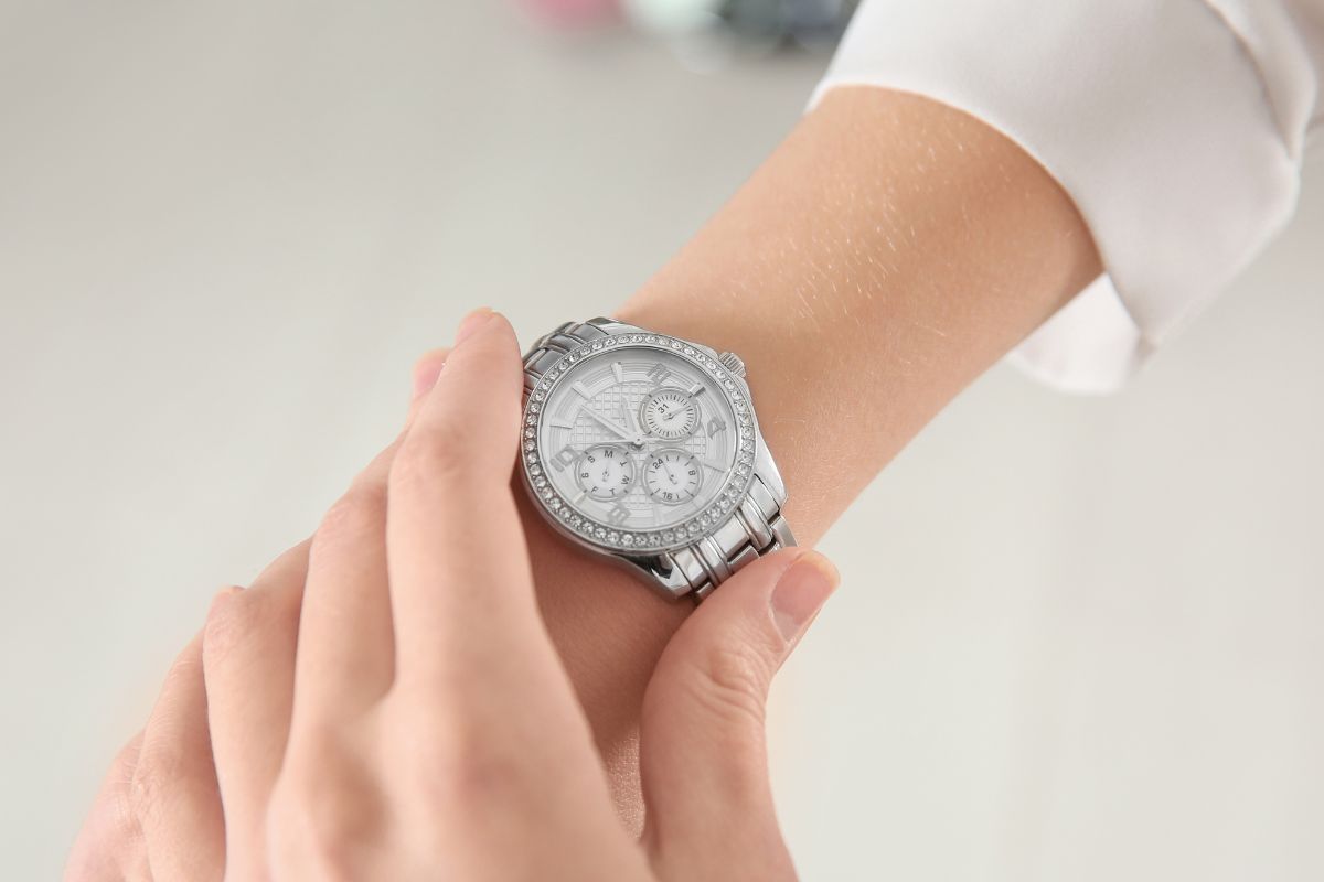A woman's hand checking her watch.