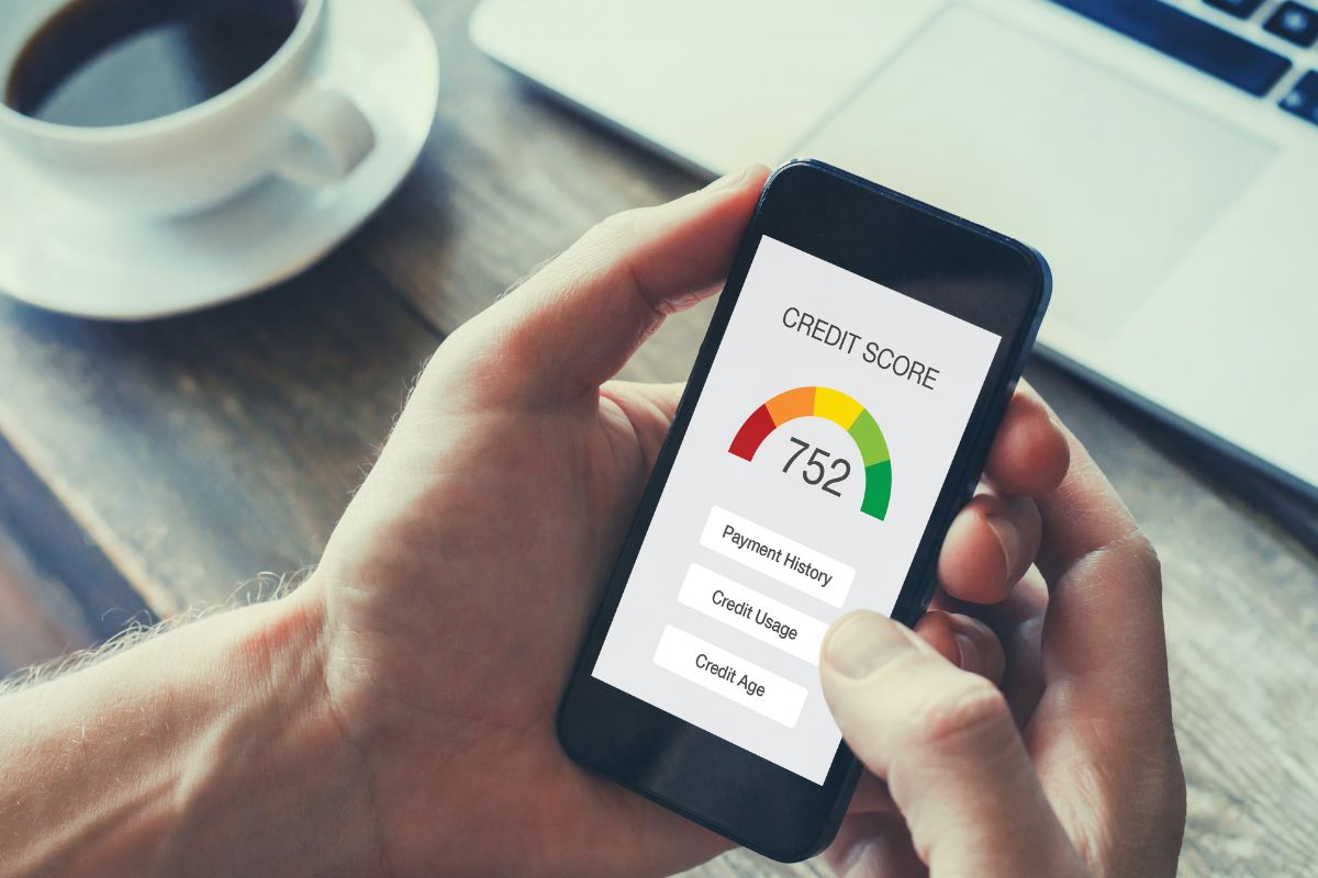 A man's hand checking his credit score.