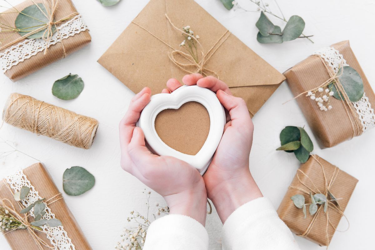 Image of a woman's hand wrapping gifts.