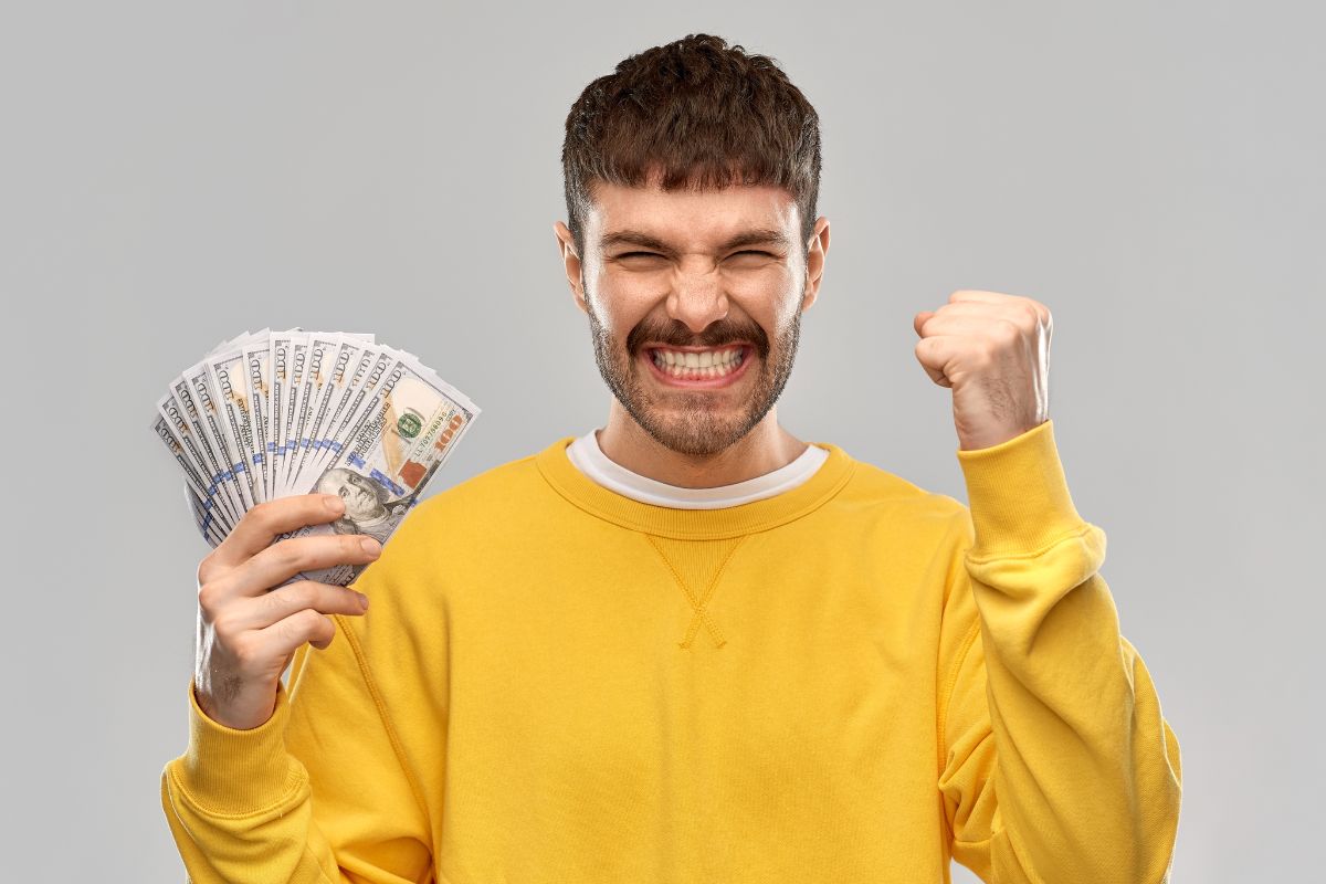 Picture of a man holding money.