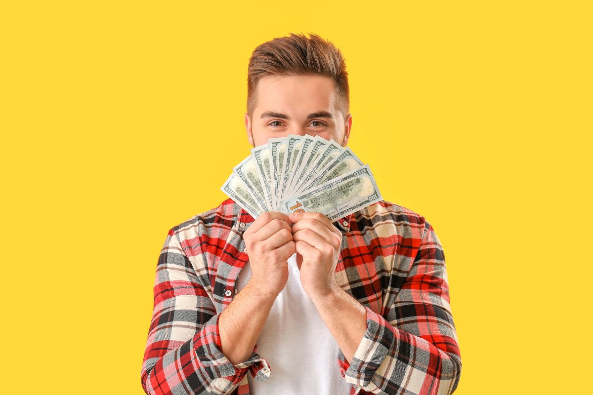Image of a man holding money.