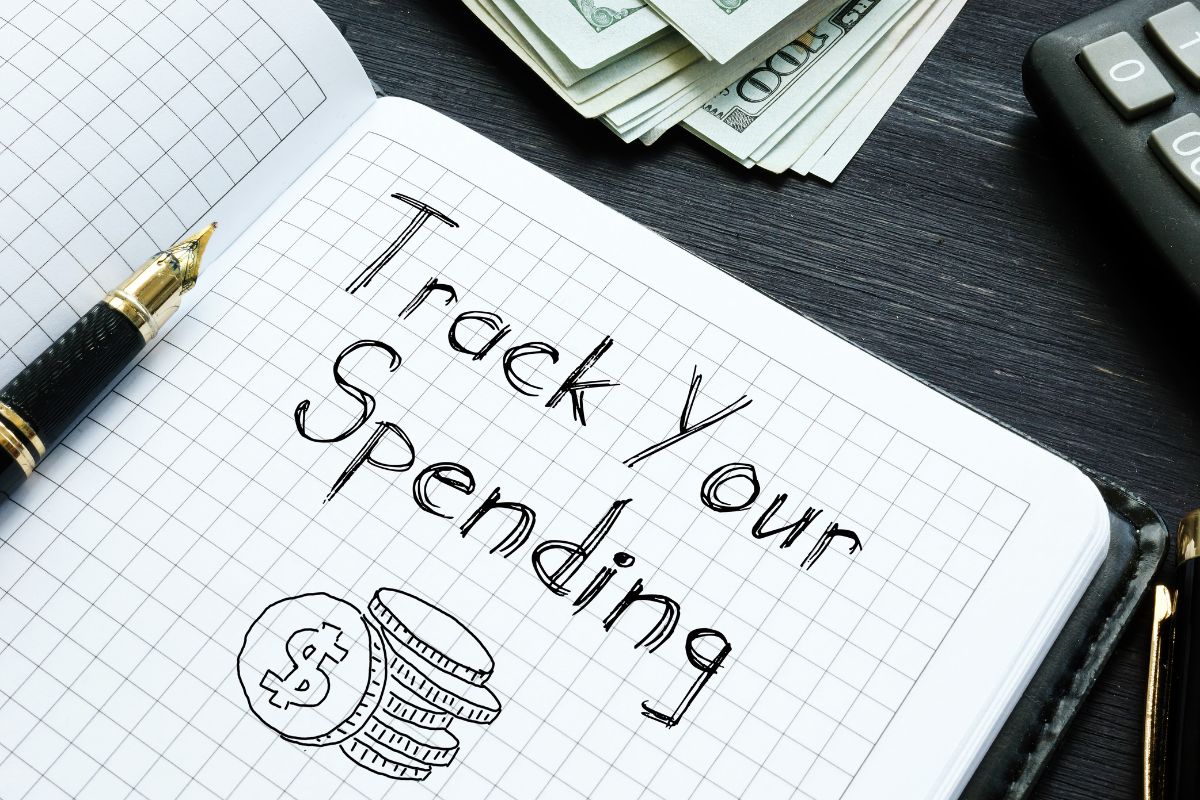 Picture of a notebook with Track your spending wording.