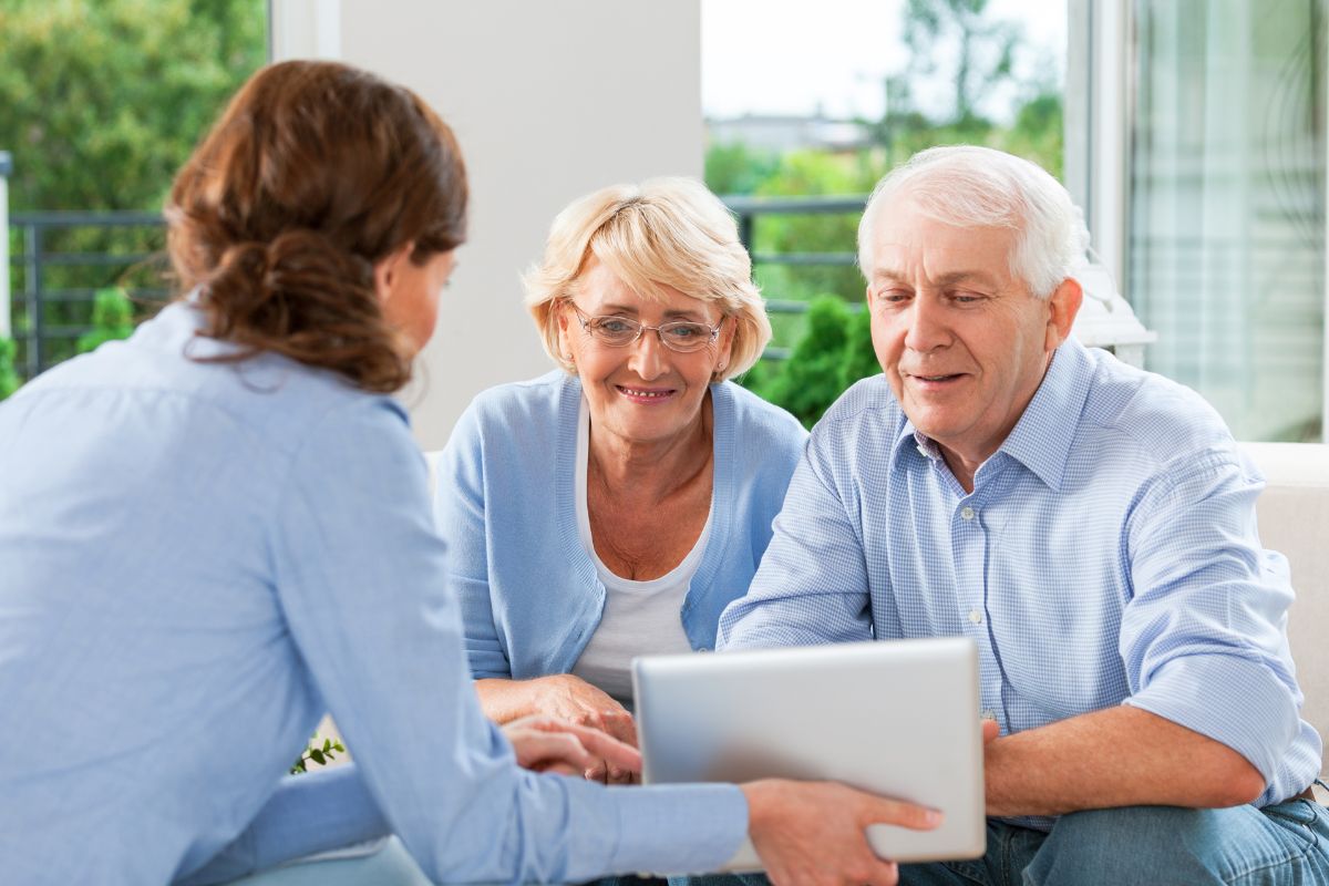 Picture of a woman teaching her aging parents.