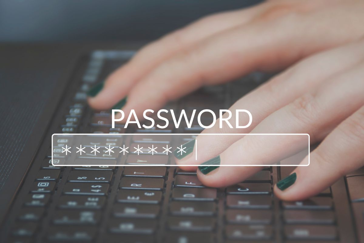 A woman's hand typing a password.