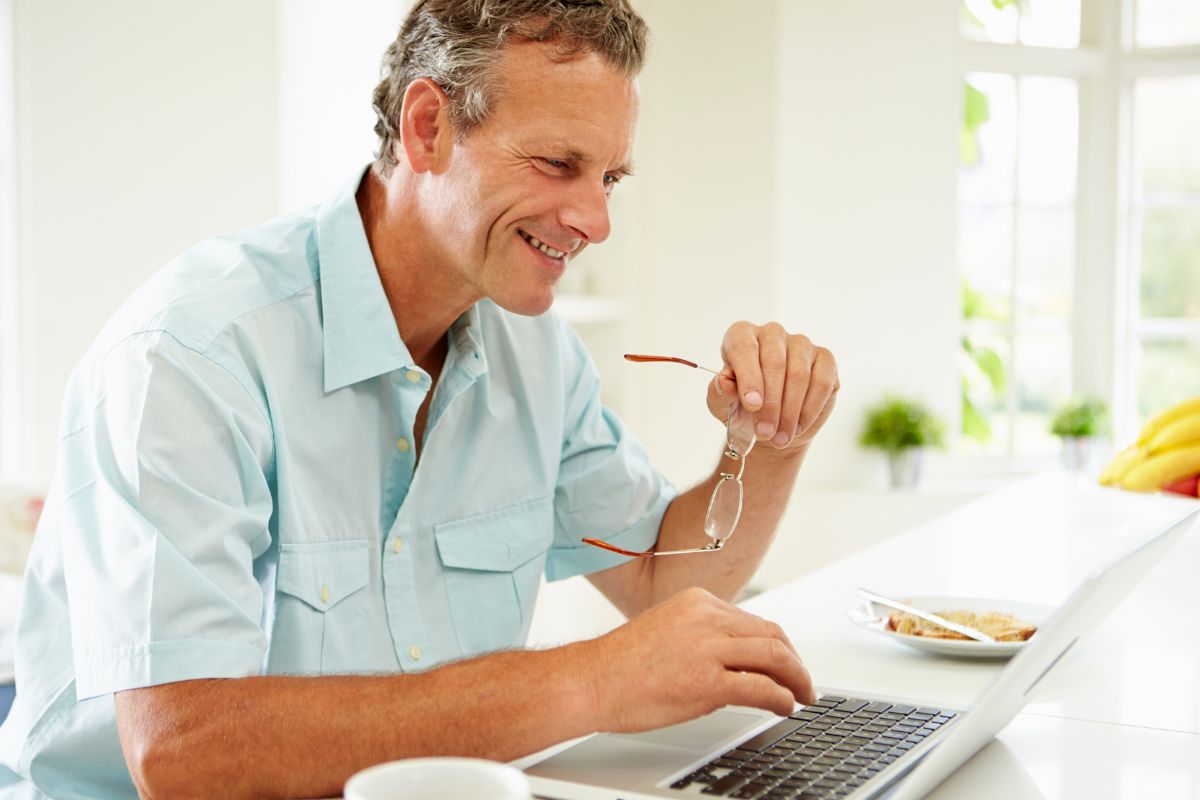 Photo of a man using a laptop.
