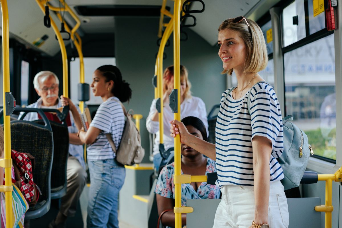 The image shows passengers in public transportation.