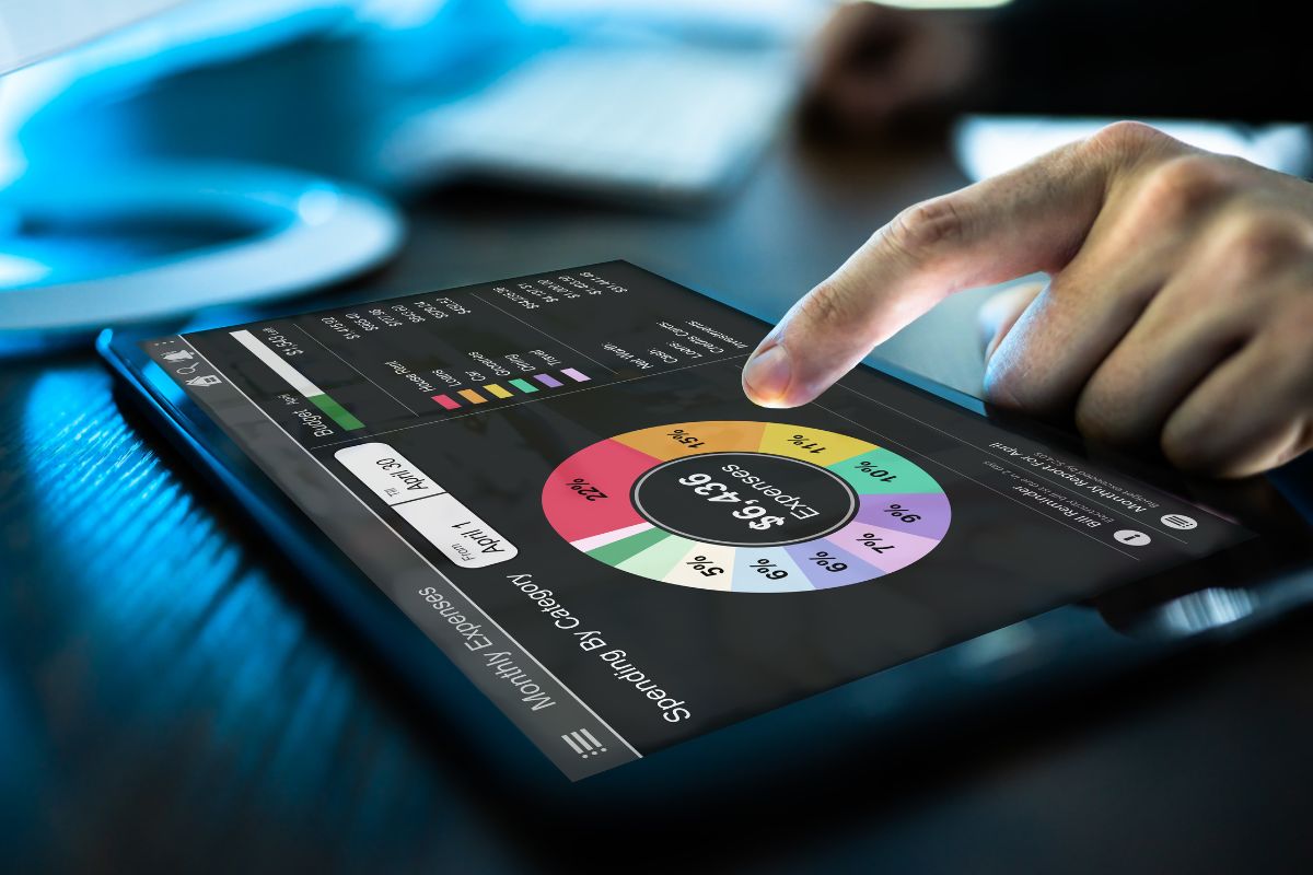 A man's hand tracking his expenses.