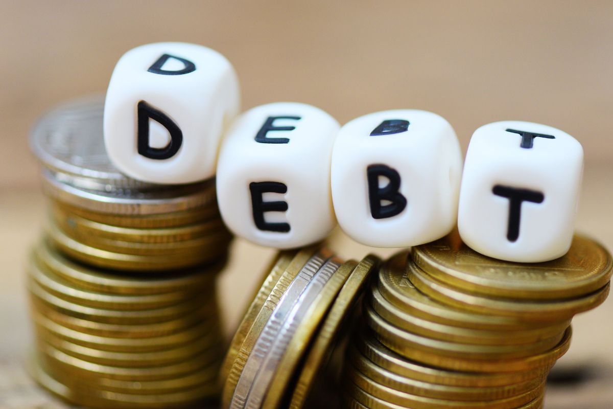 Image of coins and debt wording.