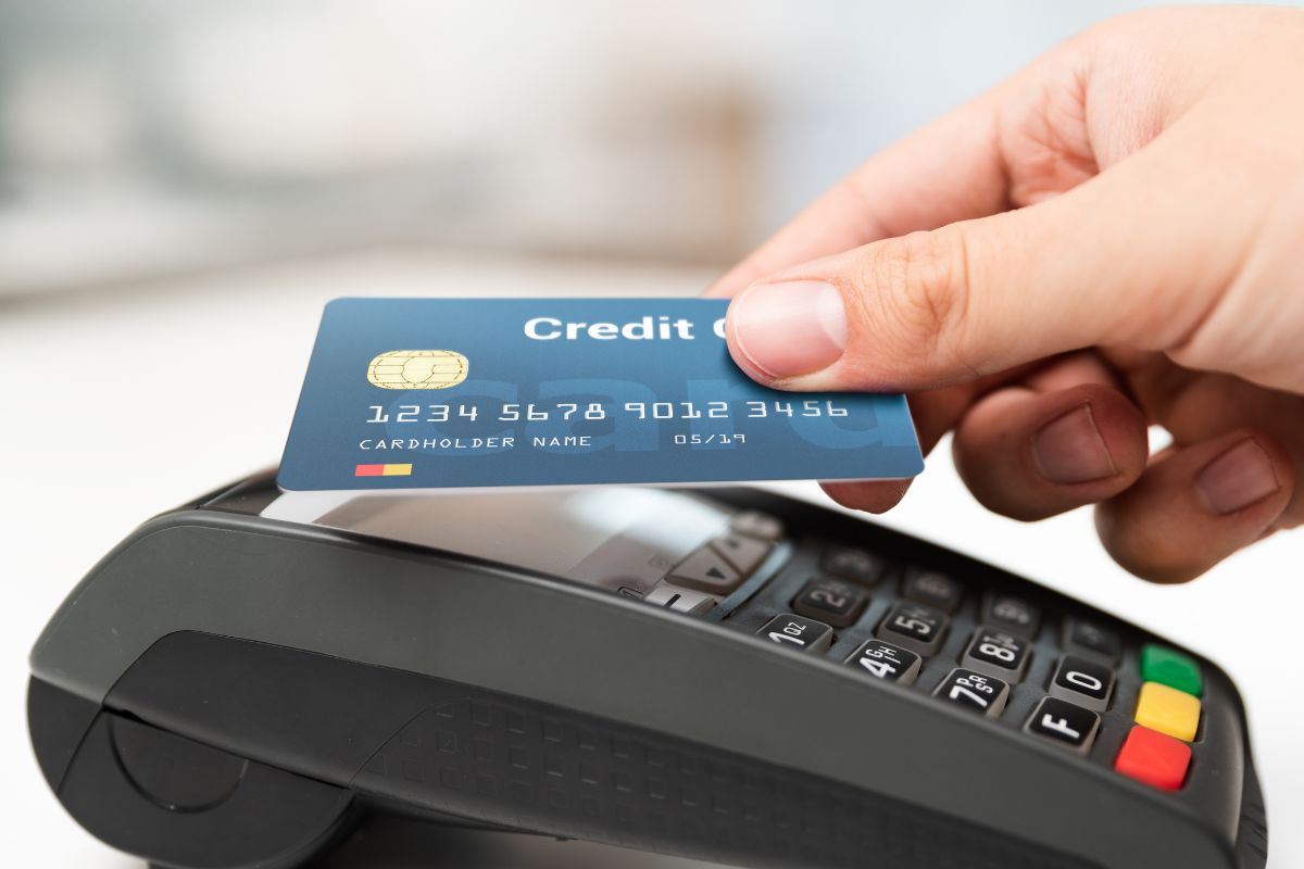 A woman's hand using a credit card.