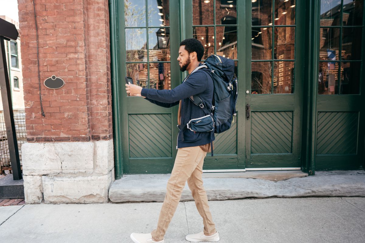 Photo of a traveler man using a phone.