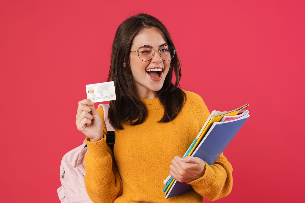 A college student holding a credit card.